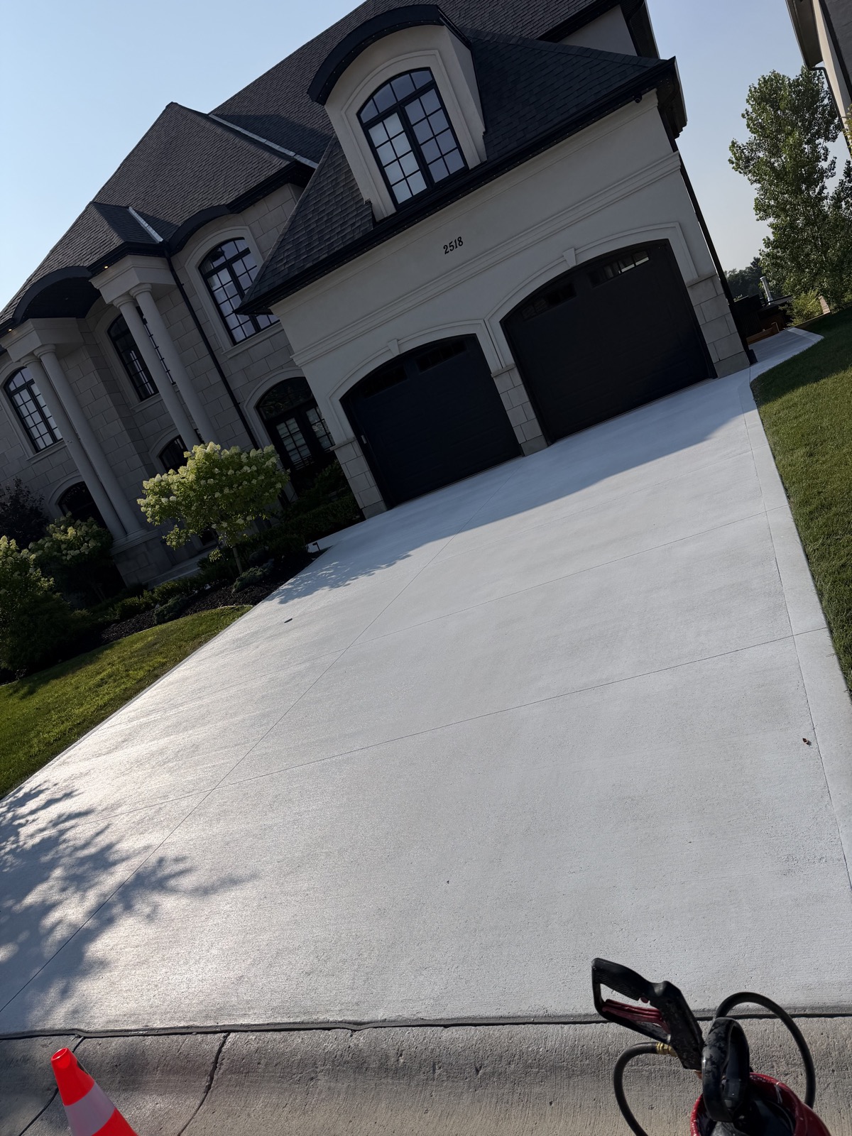 Brushed concrete driveway after recolour and sealing