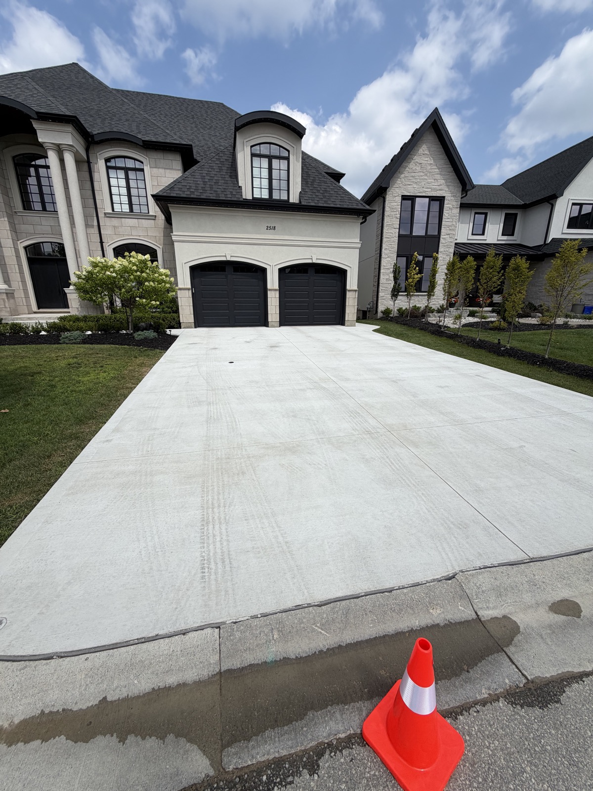 Faded broom-finish concrete driveway before restoration