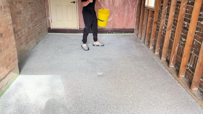 Decorative flake broadcast across a garage floor basecoat