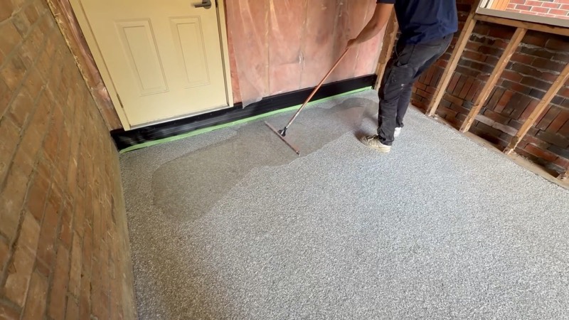 Clear topcoat being applied over a flake floor