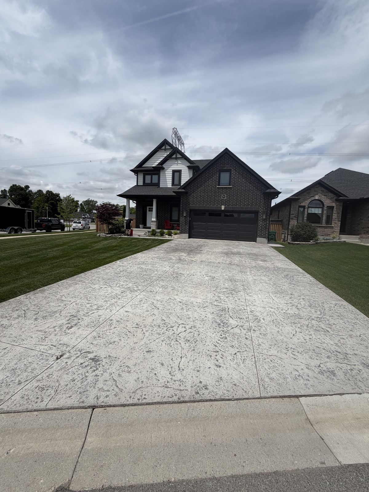 Faded stamped concrete driveway before restoration