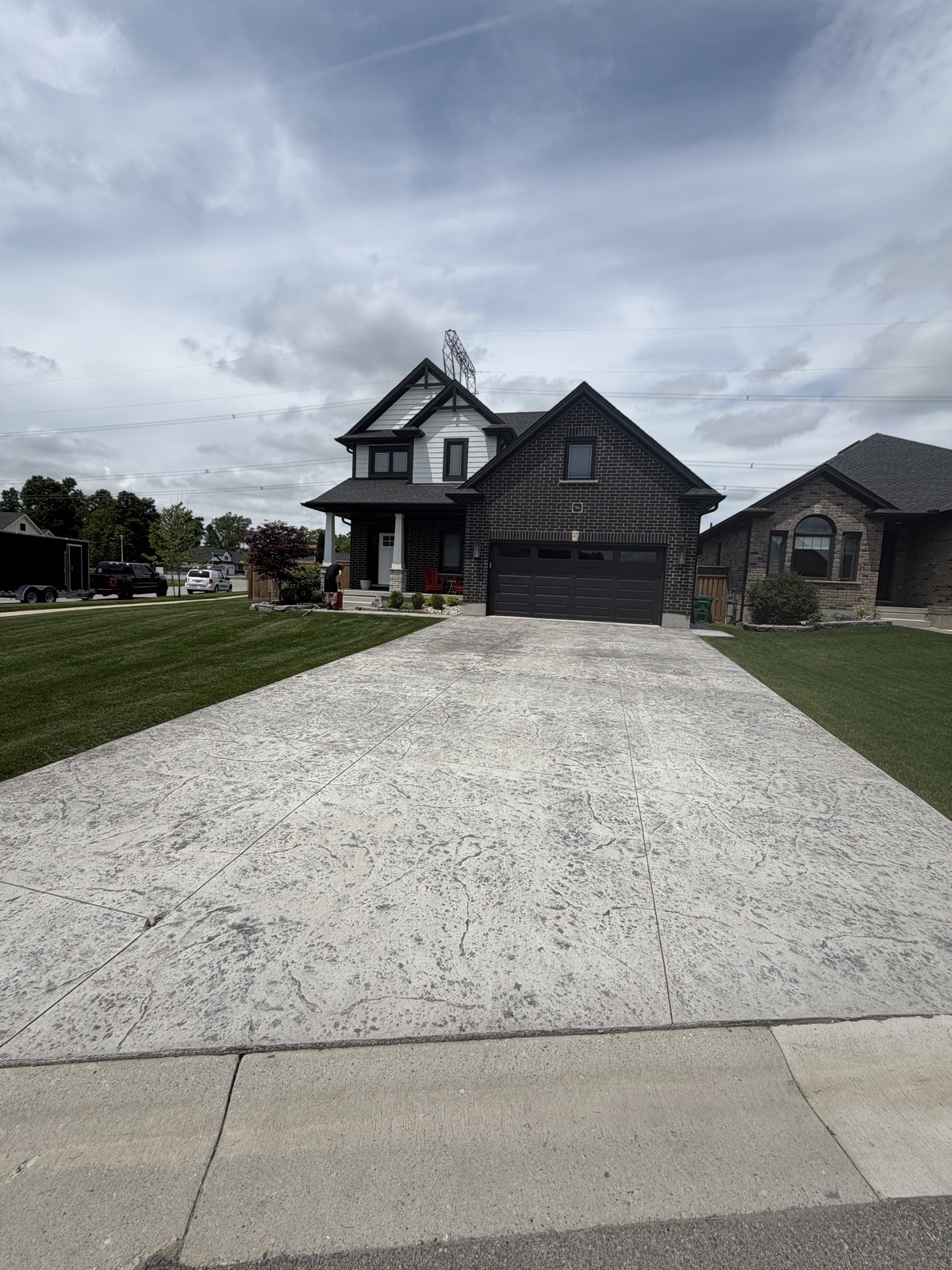 Faded stamped concrete driveway before restoration
